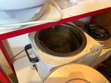 a pot that is sitting on a stand next to a blender