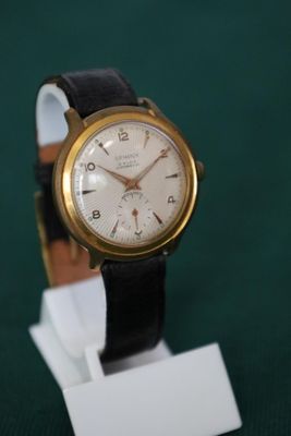 une montre posée sur un support sur une table
