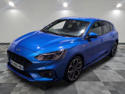 a blue ford focus is parked on a checkered floor
