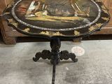 an old table with a painting on the top of it