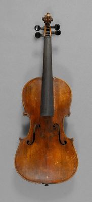 a close up of a violin hanging on a wall