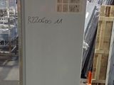 an image of a refrigerator in a warehouse with other items