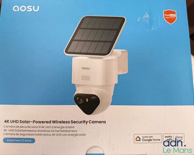 a box with a solar powered security camera inside of it