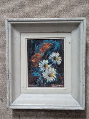 une photo d'un tableau représentant des fleurs, dans un cadre blanc