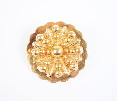 an image of a gold brooch with pearls on a white background