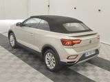the rear end of a white volkswagen suv parked in a garage