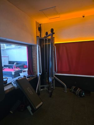 an image of a gym room with a view of a parking lot