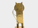 brass sculpture of a cat with a long tail on a wooden base