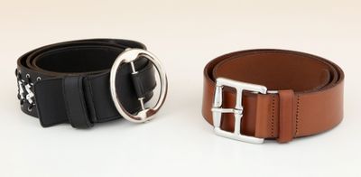 two belts with buckles on each side of them on a white surface