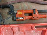 a corded drill and a corded cord in a tool box