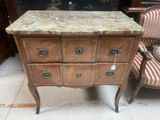 a marble top chest of drawers on display in a store