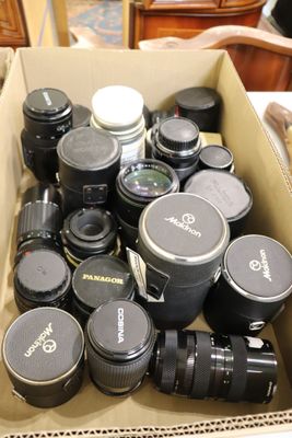 une boîte remplie d'objectifs d'appareil photo et des objectifs posés sur une table
