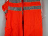an orange safety vest hanging on a hanger on a white wall