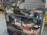 a cage filled with many different types of stuffed animals