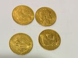 four gold sovereigns, one of which is a sovereign and one of which is a sovereign