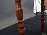 a wooden table with a glass top on a black surface