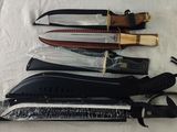 several different types of knives are lined up on a table