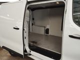a white van with its door open in a garage
