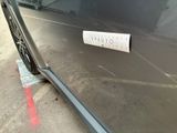 a sticker on the door of a car that is parked in a parking lot
