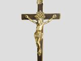 a gold cross with a crucif on a white background