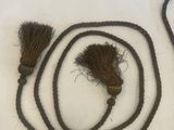 a rope with a handle and a brush on it