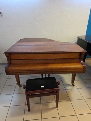 a piano that is sitting on the floor in the room