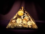 a pyramid made of rocks and shells on a purple background