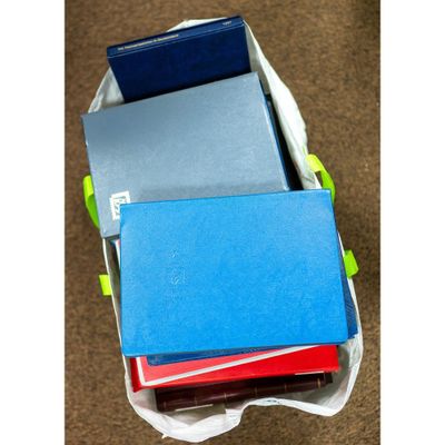 a bunch of books in a bag on the floor