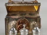 three silver containers sitting next to each other on a table