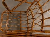 a wicker chair with a basket on top of it