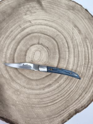 a knife sitting on top of a piece of wood