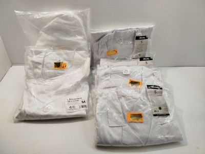 trois sacs de chemises blanches posés sur une table blanche