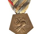 a gold medal with a red, white, and blue ribbon on it