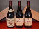 three bottles of wine sit on a table next to a wooden box