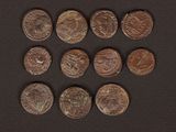 a close up of a bunch of coins on a black surface