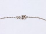 a close up of a silver chain bracelet with a pearl bead