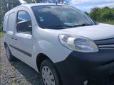 a white van that is parked in a gravel lot