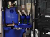 a blue machine that is sitting on top of a wooden table