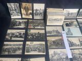 several old black and white photographs of people and vehicles on a table