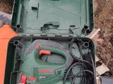 a green box with tools in it sitting on the ground