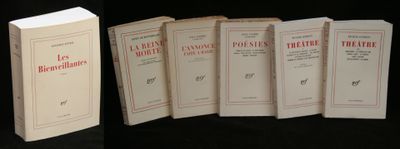 several books are lined up in a row on a black surface