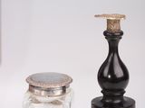 a small glass jar and a small glass jar sitting on a table