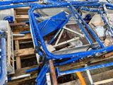 a pile of blue chairs sitting on top of a wooden pallet
