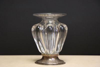 a glass vase sitting on a table with a black background