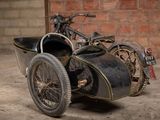 a old motorcycle with a side car attached to it