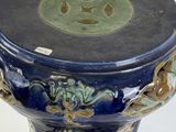 a blue and green vase with a black top