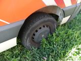 a close up of a tire on the side of a van