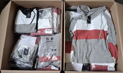 boxes of clothing are packed in a cardboard box on a table