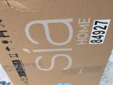 a cardboard box with a sticker on it sitting on the ground