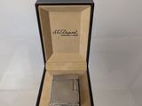 an open box with a lighter inside of it on a table